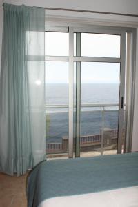 sypialnia z dużym oknem z widokiem na ocean w obiekcie Blue Views w mieście Los Sauces