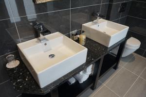 a bathroom with a white sink and a toilet at Halvard Hotel in Douglas