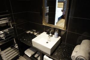 a bathroom with a sink and a mirror at Halvard Hotel in Douglas