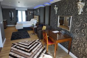 a hotel room with a bed and a desk and a bedroom at Halvard Hotel in Douglas