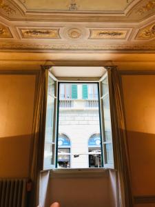 a window with a view of a building at La Santissima in Florence