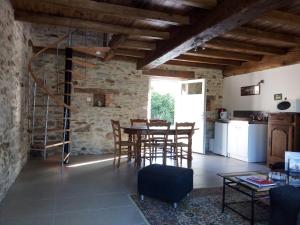 a kitchen and dining room with a table and chairs at Gites de la noue in Vendrennes