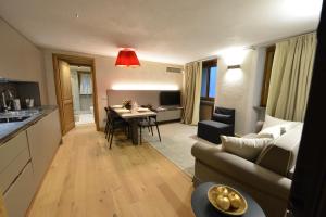 a living room and kitchen with a couch and a table at Le Reve Charmant Apartments - Via Sant'Orso,2 in Aosta