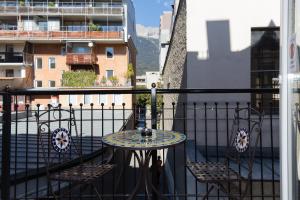 a balcony with a table and chairs on a balcony at INNSBRUCK CENTER APARTMENTS tirol in Innsbruck