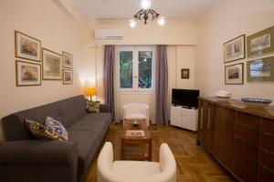 a living room with a couch and a tv at "Cultural Athens" Kolonaki, Syntagma in Athens