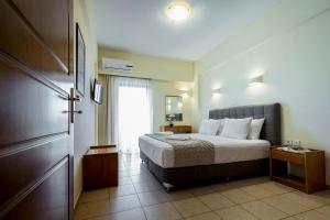 a hotel room with a bed and a window at Gramvoussa Bay in Kissamos
