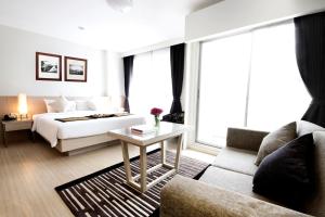 a hotel room with a bed and a couch at Classic Kameo Hotel & Serviced Apartments, Ayutthaya in Phra Nakhon Si Ayutthaya +26 photos
