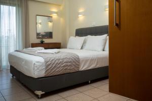 a bedroom with a large bed with white sheets and pillows at Gramvoussa Bay in Kissamos