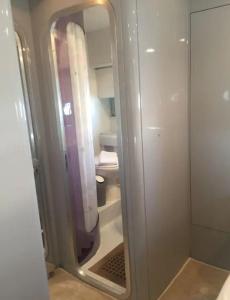 a bathroom with a shower with a mirror at Beautiful and magnific yacht in Lisbon