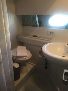a small bathroom with a toilet and a sink at Beautiful and magnific yacht in Lisbon