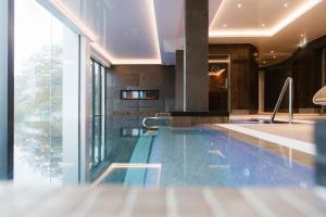 a large swimming pool with a large mirror at Low Wood Bay in Windermere