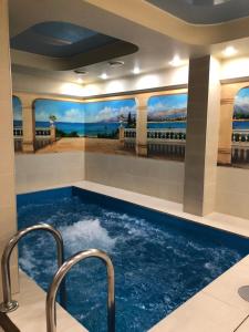 a swimming pool with two faucets in a hotel room at Hotel Aqua - Life in Krasnoyarsk