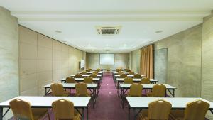 an empty room with tables and chairs and a screen at S Park Design Hotel in Vientiane +98 photos