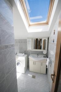 ein Badezimmer mit einem Waschbecken, einem WC und einem Dachfenster in der Unterkunft Župa Dubrovačka Guest House in Mlini