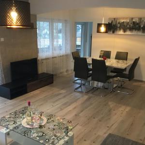 a living room with a dining room table and chairs at Sulzberg in Lahr