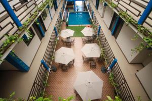 an overhead view of a building with tables and umbrellas at Hotel Castillo Del Rey in Palenque