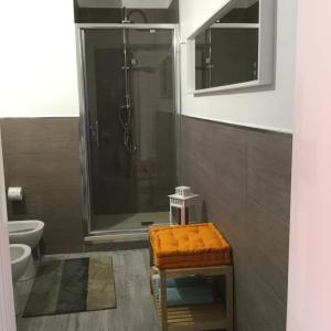 a bathroom with a shower and a toilet and a stool at Stayinbologna in Bologna