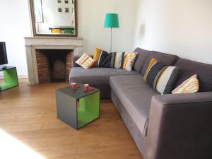 a living room with a couch and a fireplace at Home Opéra in Marseille