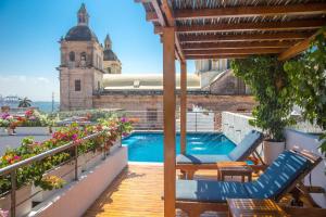 a patio with chairs and a swimming pool on a building at Casa Claver Loft Boutique Hotel in Cartagena de Indias