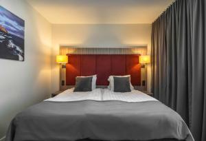 a bedroom with a large white bed with two pillows at Hotel Oxelösund in Oxelösund