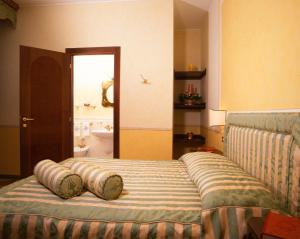 a bedroom with a bed with pillows on it at La Contrada dei Monti in Orta San Giulio