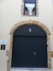 a garage door in a building with a window at Gîte ''Le nid de Bouly'' in Martres-de-Veyre