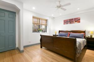 a bedroom with a bed and a ceiling fan at 2-bedroom in Upper West Side, private entrance in New York