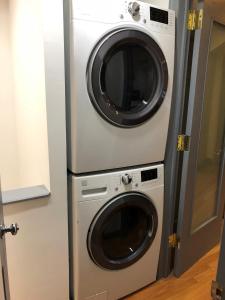 a washing machine and a washer and dryer in a room at 2-bedroom in Upper West Side, private entrance in New York
