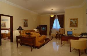 a living room with a couch and a table at Issham Hotel in Jeddah