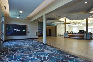 an empty lobby with a large screen tv on the wall at Bally's Twin River Lincoln Casino & Hotel in Lincoln