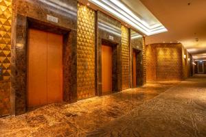 an empty hallway of a building with brick walls at Graceland Bangkok by Grace Hotel - SHA Extra Plus in Bangkok