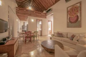 a living room with a couch and a table at Casa Claver Loft Boutique Hotel in Cartagena de Indias