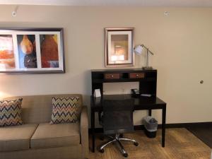 a living room with a couch and a desk with a computer at Staybridge Suites Grand Rapids-Kentwood by IHG in Grand Rapids