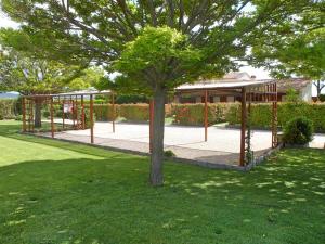 a tree in a park with a gazebo at Podere Oca Bianca in Pescia Romana