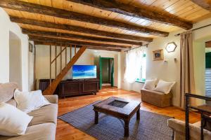 a living room with a couch and a tv at Authentic House Villa Albazora in Central Istria in Žminj