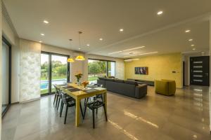 a dining room with a table and a couch at Contemporary Villa Nada with Pool and Sauna in Tinjan