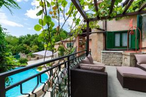 a balcony with chairs and a swimming pool at Authentic House Villa Albazora in Central Istria in Žminj