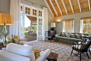 a living room with a couch and a table at 7 Koppies in Franschhoek