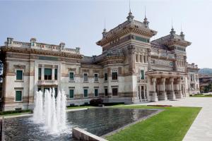 a large building with a fountain in front of it at Albergo Vittoria in Salsomaggiore Terme
