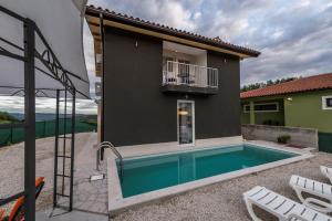 a villa with a swimming pool and a house at Villa Art House with Pool in Vižinada