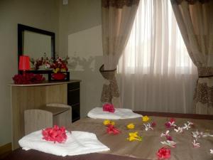 a bedroom with two beds with flowers on the bed at Les Lauriers in Flic-en-Flac