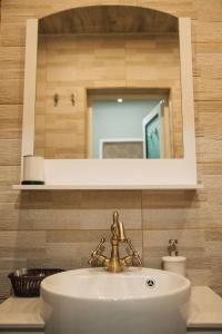 a bathroom with a sink and a mirror at Апартамент Барок in Lovech +13 photos