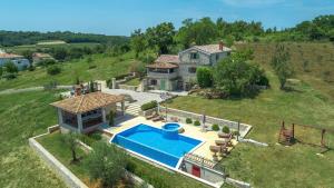 an aerial view of a house with a swimming pool at Unique Villa Bošket with Pool and Jacuzzi surrounded by Nature in Vižinada