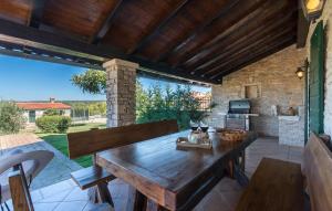 an outdoor patio with a wooden table and a kitchen at Villa Luna in Selina in Selina