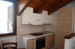 a kitchen with white cabinets and a stove top oven at B&B Al Vicoletto in Fisciano