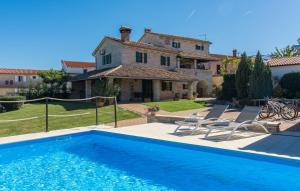 a villa with a swimming pool in front of a house at Villa Luna in Selina in Selina
