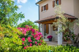 a house with pink flowers in front of it at Villa Salambati in Smoljanci