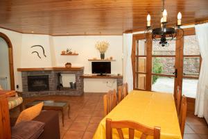 a dining room with a table and a fireplace at Turisme Rural Lo Pallé de Cal Bosch in Llagunes
