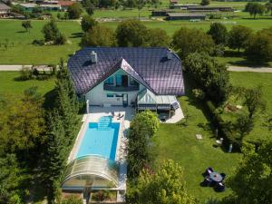 an overhead view of a house with a swimming pool at Modrin Apartments in Kamnik