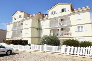 a large white building with a white picket fence at Peteh in Poreč